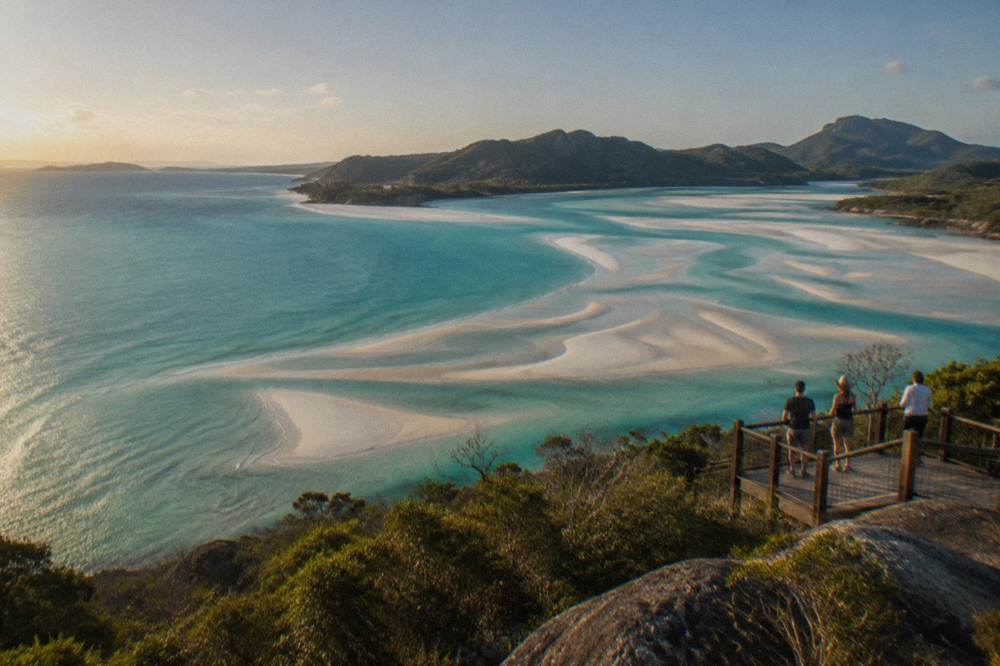 Aerial view of tidal sand patterns in turquoise shallow water at a northern beach end