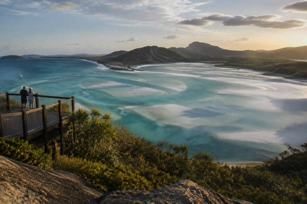Turquoise water swirling through white silica sand at a tidal inlet