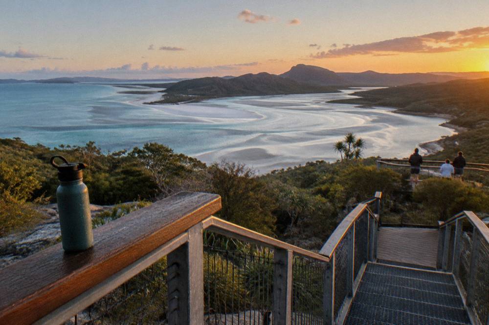 View from a wooded headland over turquoise tidal shallows winding through white sand