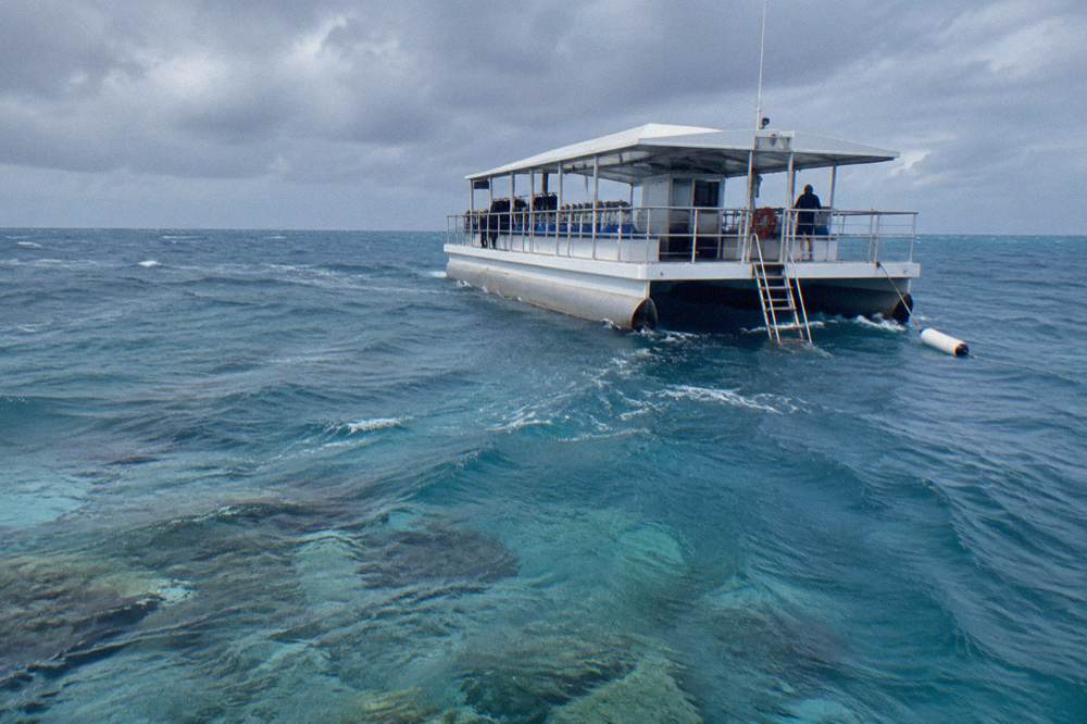 Reef pontoon moored over pale blue open water far from land