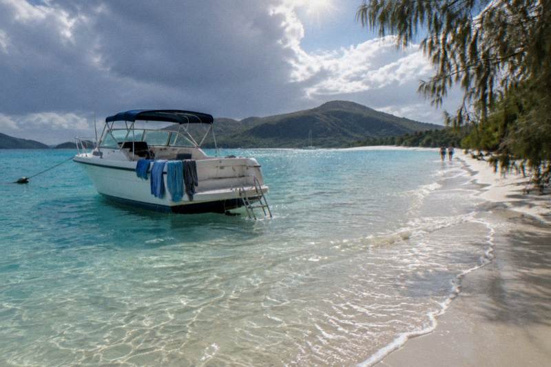 A day boat anchored off the white silica sand of Whitehaven Beach