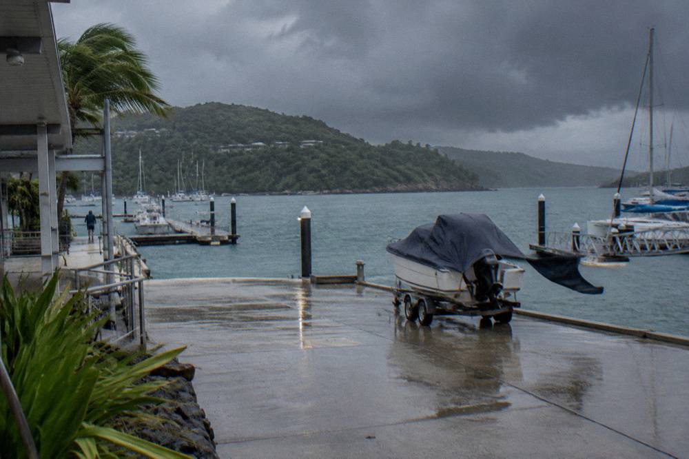 Dark storm clouds building over green Whitsunday islands and calm sea