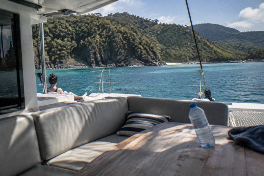 A sheltered deck seating area on a large cruising catamaran