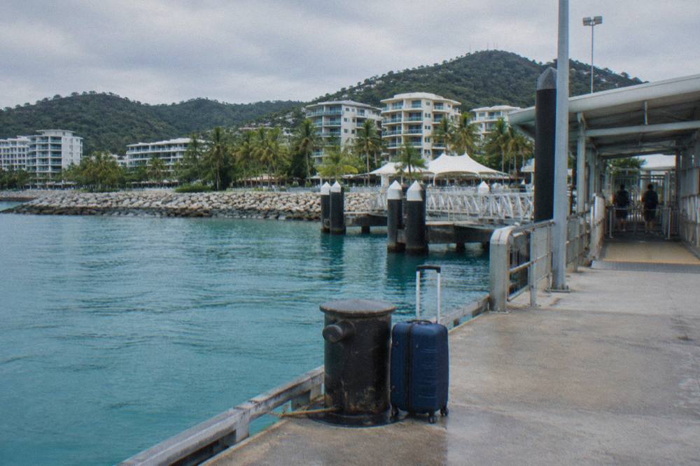 Ferry terminal jetty at a tropical mainland port with calm blue water