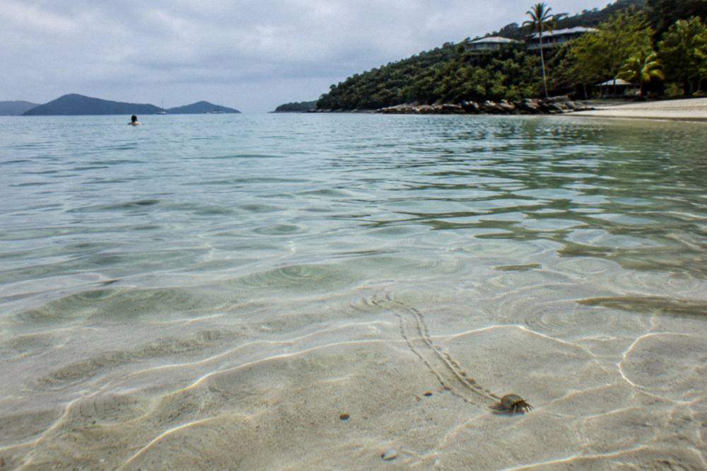 Close view of clear shallow water over pale sand with ripples